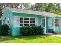 Charming light teal home with white shutters, landscaping, and walkway at 2600 46Th S St, Gulfport, FL 33711
