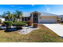 Single-story home with landscaped yard and attached garage at 72 Norman St, Port Charlotte, FL 33954