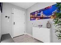 Bright entryway with built-in bench, storage cabinet, and large wall art at 1120 E Kennedy Blvd # 1514, Tampa, FL 33602
