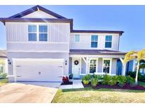 Two-story home with gray siding, landscaping, and a two-car garage at 3013 61St E Dr, Ellenton, FL 34222