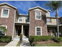 Inviting 2-story townhome with stone accents and landscaping at 31247 Claridge Pl, Wesley Chapel, FL 33543