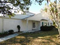 White single story home with mature landscaping and a spacious yard at 4708 Lacrosse Ct, New Port Richey, FL 34655