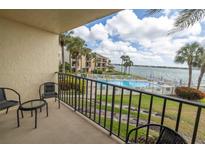 Balcony view of waterfront pool and bay at 7520 Sunshine Skyway S Ln # T18, St Petersburg, FL 33711