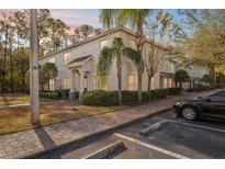 Two-story townhome with light-colored siding, landscaping, and a paved walkway at 9626 Charlesberg Dr, Tampa, FL 33635
