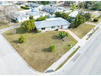 Aerial view of a single-story house with a large front yard and driveway at 1004 Orlando Ave, Bradenton, FL 34207