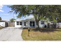 Newly renovated home with a carport and well-manicured lawn at 8719 92Nd Ter, Seminole, FL 33777