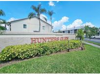 Hunters Glen community entrance sign with lush landscaping at 2067 Hunters Glen Dr # 313, Dunedin, FL 34698