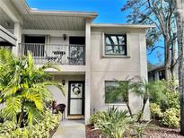 Charming two-story condo with a balcony, lush landscaping, and a welcoming entrance at 2150 Elm St # 605, Dunedin, FL 34698