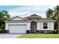 One-story home with stone accents and a two-car garage at 32443 Osprey Peak Way, San Antonio, FL 33576