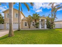 Two-story house with attached garage, lush lawn, and palm trees at 538 25Th Se Ave, St Petersburg, FL 33705