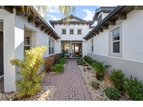 Elegant entryway with brick walkway and lush landscaping at 5610 Tidewater Preserve Blvd, Bradenton, FL 34208