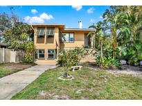 Charming home featuring unique architectural elements with lush, tropical landscaping and a well-maintained lawn at 861 20Th N Ave, St Petersburg, FL 33704