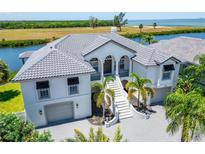 Luxury waterfront home with tile roof and three car garage at 1024 Sonata Ln, Apollo Beach, FL 33572