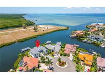 Aerial view of waterfront home with private dock and boat lift at 1024 Sonata Ln, Apollo Beach, FL 33572