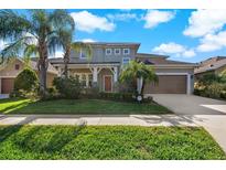 Two-story house with a brown garage door and landscaping at 1317 Lorea Ln, Brandon, FL 33511