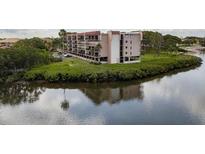 Aerial view of waterfront condo building with lush landscaping at 2700 Bayshore Blvd # 11302, Dunedin, FL 34698