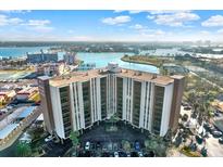 Aerial view of a condo building with water access and parking at 10355 Paradise Blvd # 503, Treasure Island, FL 33706