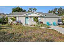Cute single story home with a teal door and nicely landscaped yard at 1224 Palm St, Clearwater, FL 33755