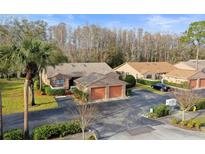 Attractive villa with a two-car garage and lush landscaping at 3185 Charter Club Dr # A, Tarpon Springs, FL 34688
