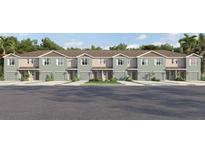 New townhome community with 2-car garages, front yards, and neutral-color exteriors at 4449 Rachel Falls Dr, Tampa, FL 33610