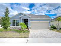 Curb appeal abounds in this charming one-story home featuring a paver driveway and landscaped yard at 6112 Plover Meadow St, Lithia, FL 33547