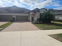 Two-story house with a brick driveway and landscaped yard at 16866 Balance Cv, Land O Lakes, FL 34638