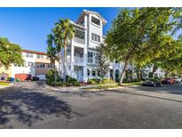 Luxury townhome with white exterior, palm trees, and a desirable location at 6002 Yeats Manor Dr # 101, Tampa, FL 33616