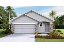 One-story home with gray exterior, stone accents, and a two-car garage at 6963 Broad River Ave, Land O Lakes, FL 34638
