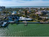 Aerial view of waterfront property with private dock and expansive water views at 981 Bay Esplanade, Clearwater Beach, FL 33767