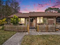 Inviting condo exterior featuring a charming wooden fence and walkway at 106 Edgewood Ct, Oldsmar, FL 34677