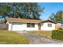 Ranch style home with carport and well-maintained lawn at 11129 101St Ave, Seminole, FL 33772