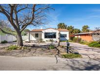 Charming single-story home with a newly renovated exterior and spacious front yard at 15804 Redington Dr, Redington Beach, FL 33708