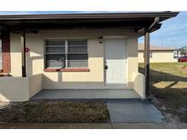 Updated condo exterior featuring a private entrance and covered porch at 24862 Us Highway 19 N # 2106, Clearwater, FL 33763