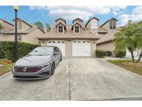 Two-story townhome with attached double garage and driveway at 2794 Countryside Blvd # 1, Clearwater, FL 33761