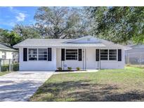 Charming newly painted white house with black shutters and a well-manicured lawn at 5836 8Th St, Zephyrhills, FL 33542