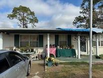 Ranch style home with covered porch and mature trees at 6916 Thrasher Dr, Tampa, FL 33610