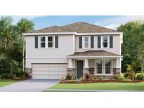 Two-story house with stone accents and a two-car garage at 3550 Thistle Bank Ct, Plant City, FL 33565