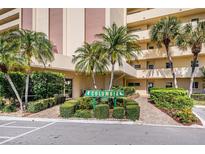 Condo building exterior showcasing manicured landscaping and inviting entrance at 4725 Cove Cir # 211, St Petersburg, FL 33708