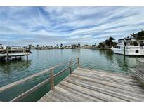 Private wooden dock offering waterfront access and views at 6437 1St Palm Pt, St Pete Beach, FL 33706