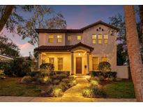 Two-story house with a walkway, landscaping, and a charming facade at 811 19Th N Ave, St Petersburg, FL 33704