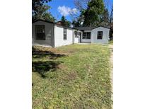 Charming white house with black trim and a spacious yard at 8465 N Tobay Rd, St Petersburg, FL 33702