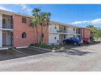 Brick building exterior with parking and tropical landscaping at 4520 Overlook Ne Dr # 238, St Petersburg, FL 33703