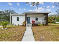 Newly built home with modern facade, landscaped yard, and walkway at 524 S Grosse Ave, Tarpon Springs, FL 34689