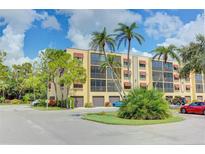 Condo building with palm trees and parking at 5849 Park N St # 201, St Petersburg, FL 33709