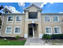 Exterior view of a two-story building with stairs leading to the entrance at 6022 Portsdale Pl # 102, Riverview, FL 33578
