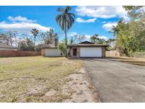 Single-story house with a spacious lawn and attached garage at 904 Orange Blossom Ln, Seffner, FL 33584