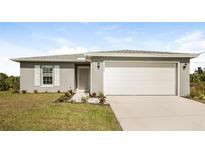 Gray house with white garage door, landscaping, and driveway at 19474 Strathcona Ave, Port Charlotte, FL 33954