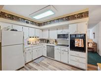 Bright kitchen featuring stainless steel appliances and wood-look flooring at 2430 Florentine Way # 38, Clearwater, FL 33763