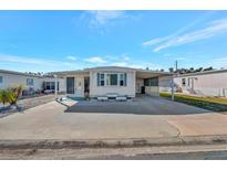 Single-wide mobile home with carport and spacious paved driveway at 322 S Port Royal Ln, Apollo Beach, FL 33572