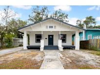 Charming renovated bungalow with a front porch and well-maintained yard at 1203 E 24Th Ave, Tampa, FL 33605